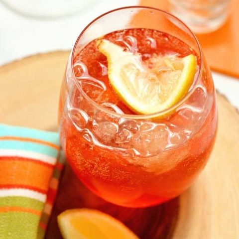 This Aperol Rose is a mix of aperol, lemon vodka, sparkling rose, honey and lemon. It's a great summer drink recipe!