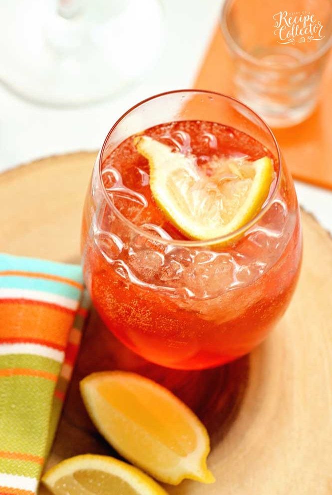 This Aperol Rose is a mix of aperol, lemon vodka, sparkling rose, honey and lemon. It's a great summer drink recipe!