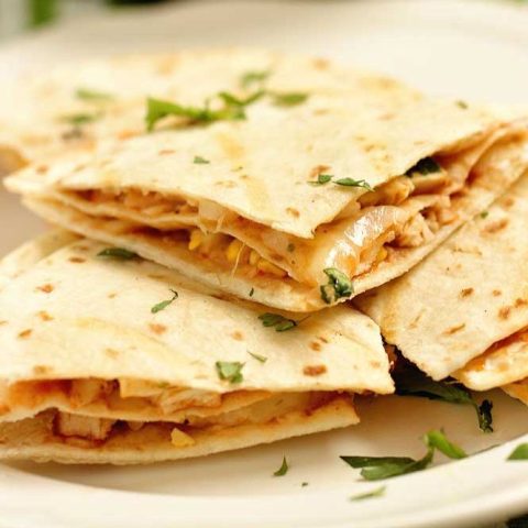 These Barbecue Chicken Quesadillas are triple-stacked with chicken, shredded cheese, grilled corn, thinly sliced onions, cilantro, and barbecue sauce. They make a fun grilling recipe!!