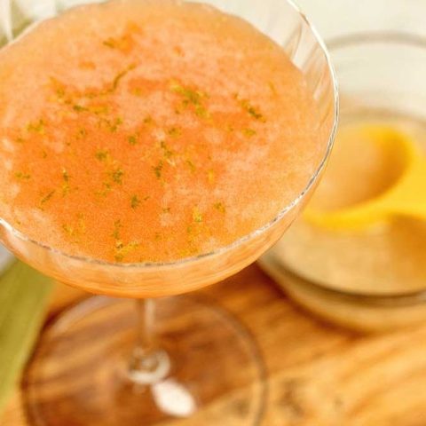 Pink Sunrise Cocktail - A lovely blend of vodka, aperol, Coco Lopez, pineapple juice, and lime zest! It's a perfect summer drink!