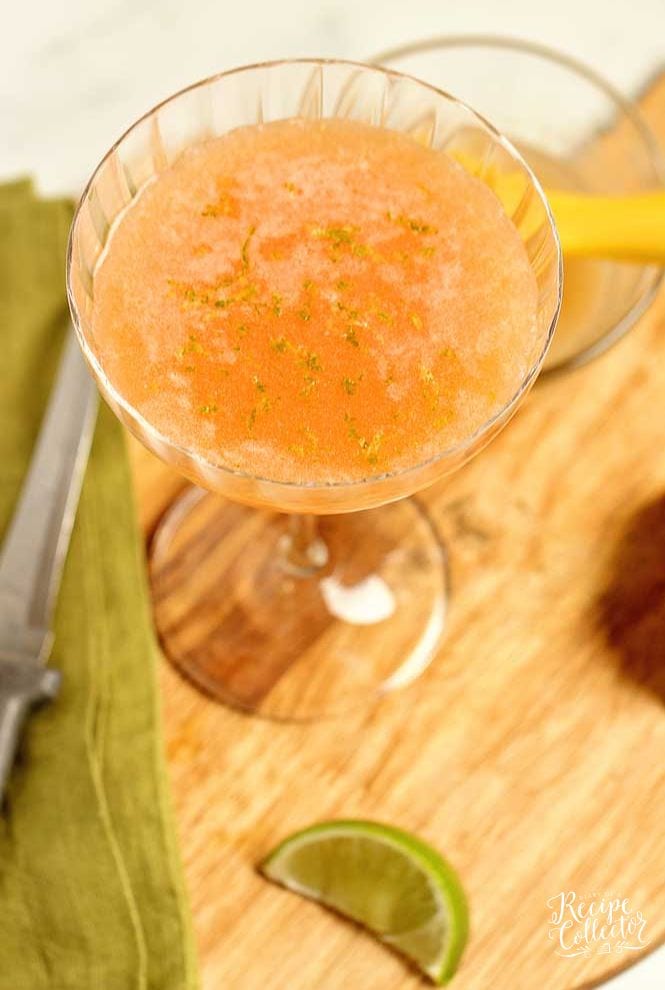 Pink Sunrise Cocktail - A lovely blend of vodka, aperol, Coco Lopez, pineapple juice, and lime zest! It's a perfect summer drink!