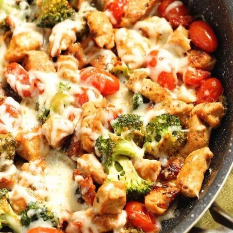 Low-Carb Tuscan Chicken - An easy low-carb healthy one pan dish filled with chicken breasts, broccoli, grape tomatoes, sun-dried tomatoes, spices, and a creamy light sauce and topped with cheese. It's great for meal prep too!